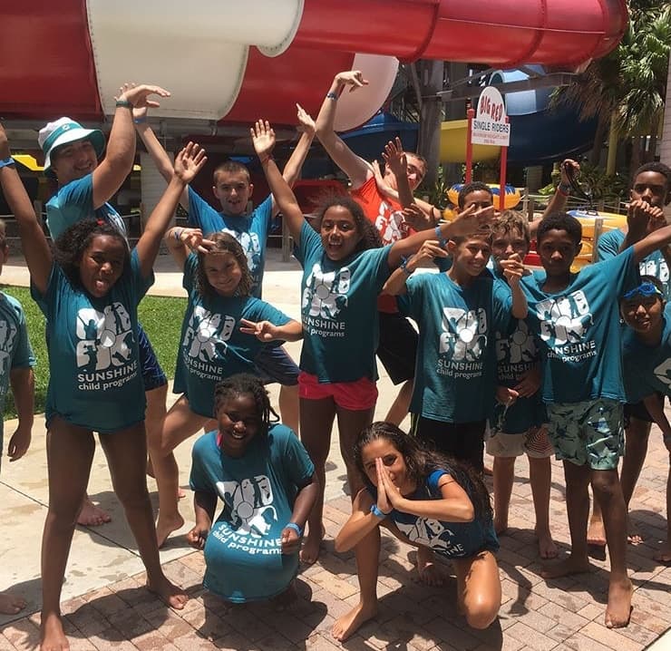Sunshine campers celebrating at a water park